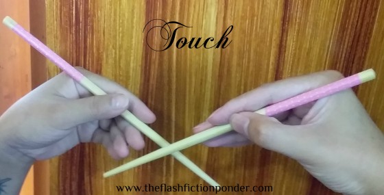 Two different hands, each holding a chopstick, image for the music video script Touch by Rico Lamoureux of The Flash Fiction Ponder, song by 6 Cycle Mind.